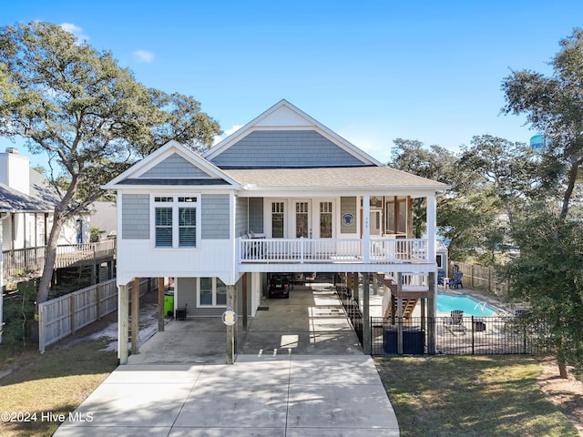 coastal home featuring a carport and a porch