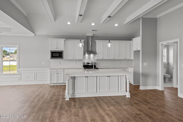 carpeted empty room with crown molding, a raised ceiling, and plenty of natural light