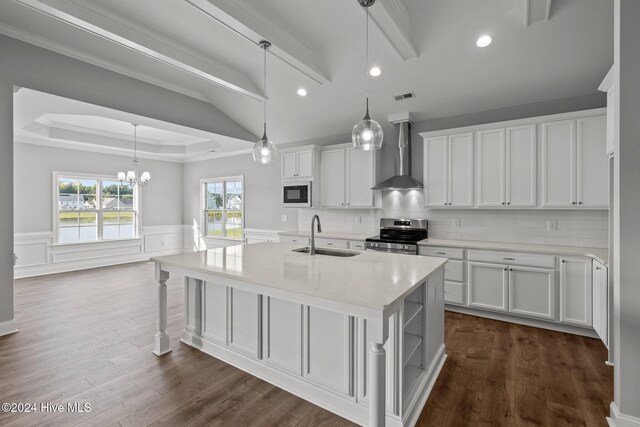 unfurnished dining area with ornamental molding, a water view, a tray ceiling, and a notable chandelier