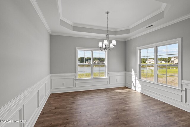 kitchen with electric stove, built in microwave, wall chimney range hood, and white cabinetry