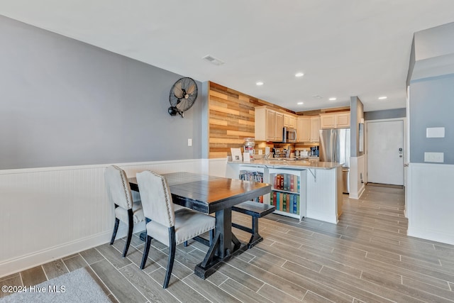 dining area featuring wooden walls