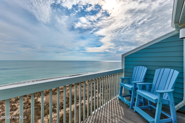 balcony with a view of the beach and a water view