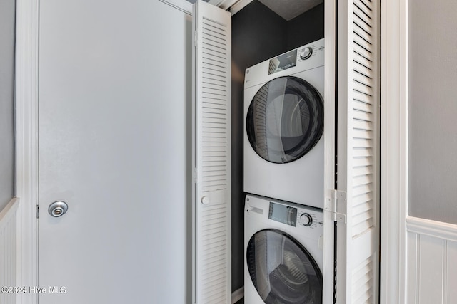 laundry room with stacked washing maching and dryer