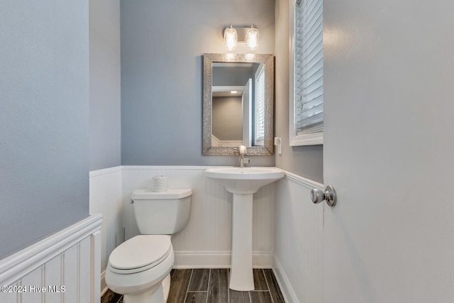 bathroom with hardwood / wood-style flooring and toilet