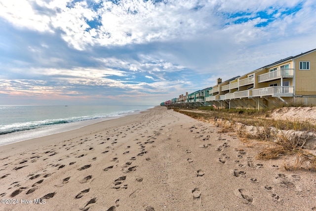 exterior space featuring a water view and a beach view