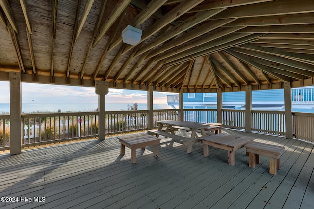 wooden terrace featuring a water view