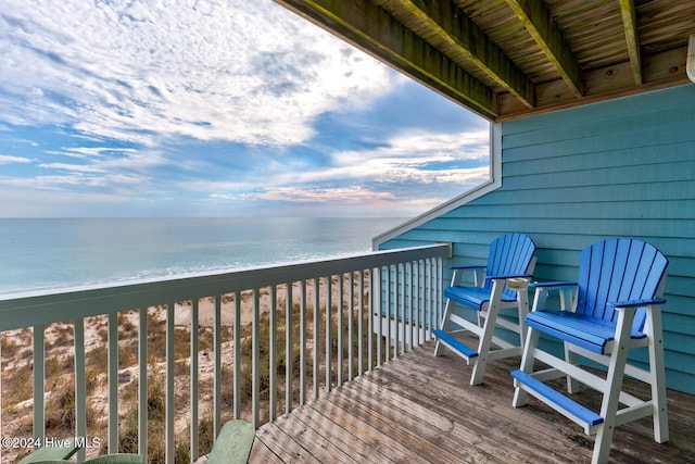 balcony featuring a water view and a view of the beach