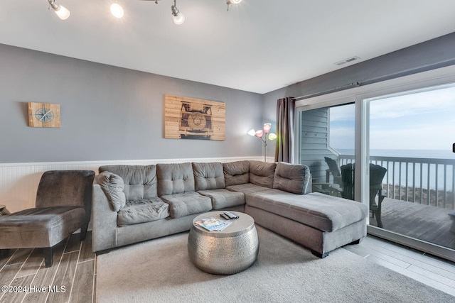 living room with hardwood / wood-style floors and a water view