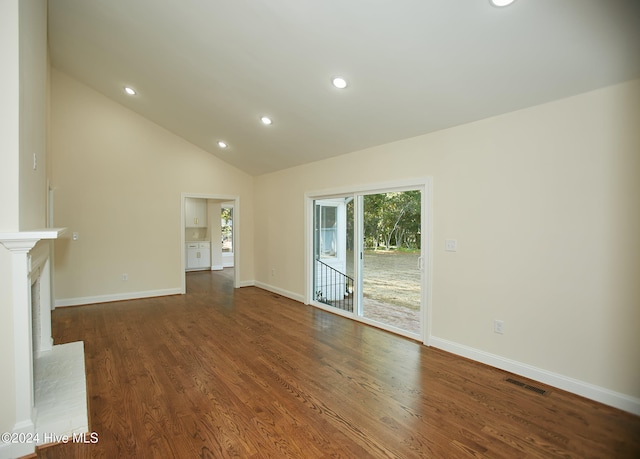 unfurnished living room featuring high vaulted ceiling, dark wood-type flooring, and a brick fireplace