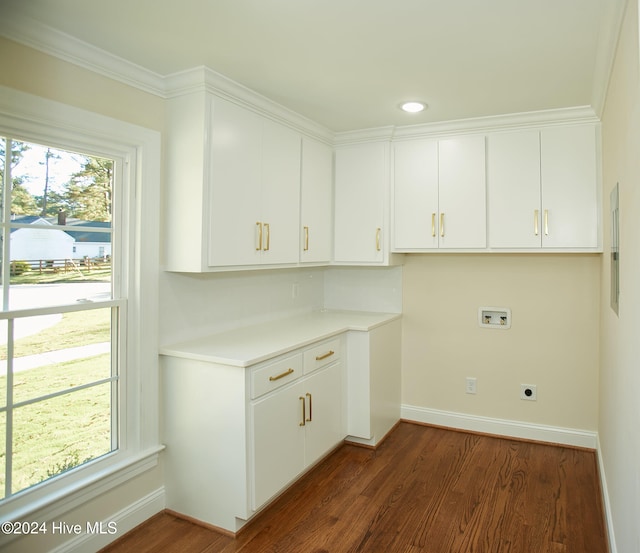 laundry room with washer hookup, ornamental molding, and dark wood-type flooring