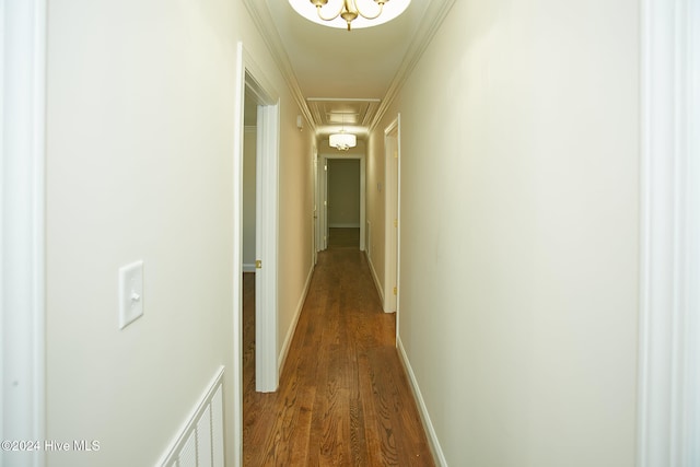 hallway with hardwood / wood-style flooring and crown molding