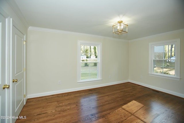 1204 Windemere Pl NW, Wilson, NC 27896 - empty room featuring plenty of natural light, a chandelier, baseboards, crown molding, and dark wood-style floors