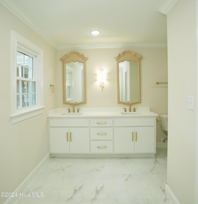 1204 Windemere Pl NW, Wilson, NC 27896 - bathroom with baseboards, double vanity, toilet, crown molding, and marble finish flooring