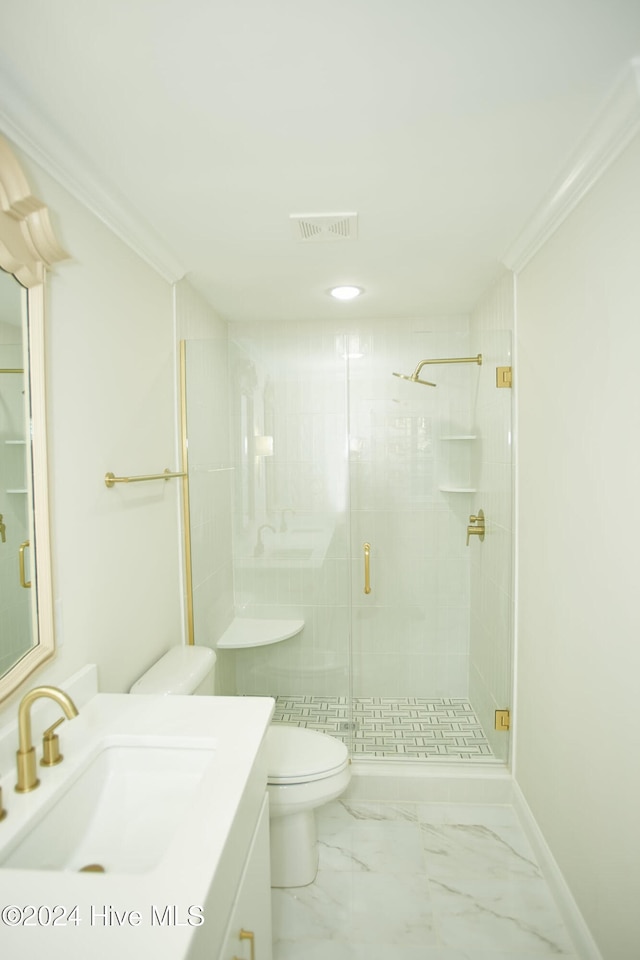 bathroom featuring vanity, toilet, a shower with door, and crown molding