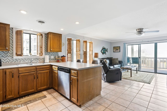 kitchen with dishwasher, plenty of natural light, sink, and kitchen peninsula