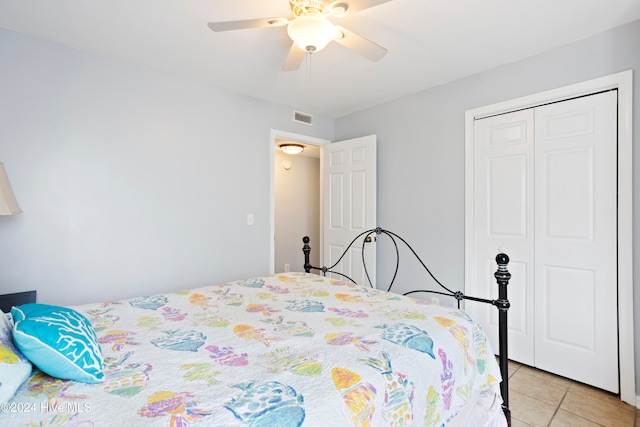 tiled bedroom with a closet and ceiling fan