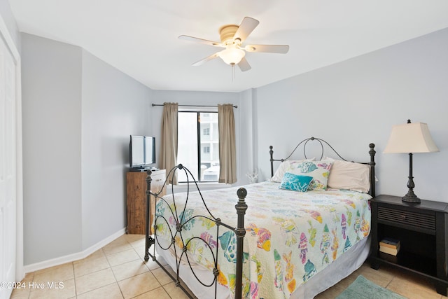 tiled bedroom with ceiling fan