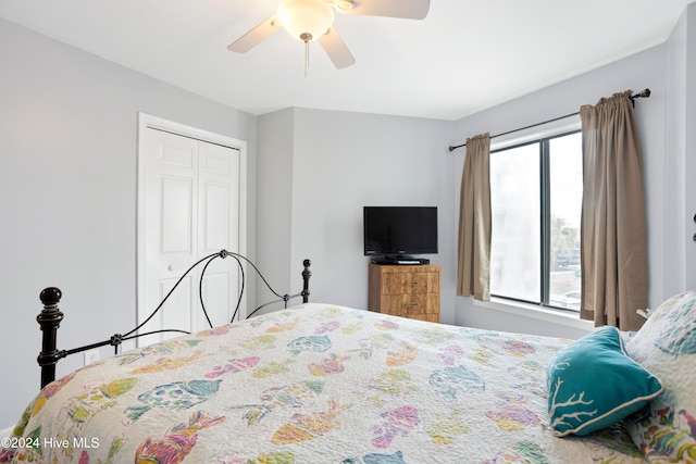 bedroom featuring ceiling fan, a closet, and multiple windows