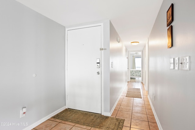 hall with light tile patterned flooring