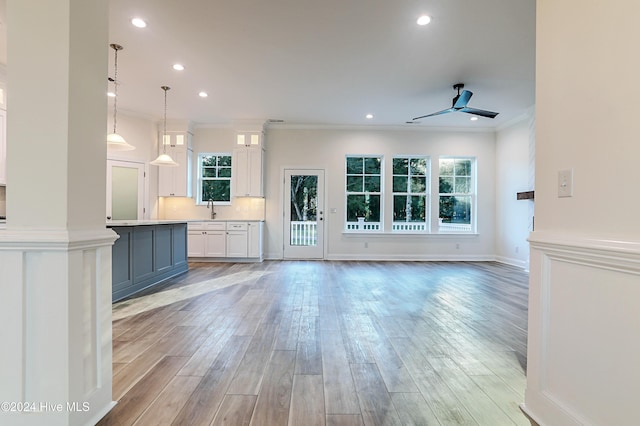 115 Genoes Point Rd SW, Supply, NC 28462 - unfurnished living room with a sink, crown molding, a ceiling fan, plenty of natural light, and recessed lighting