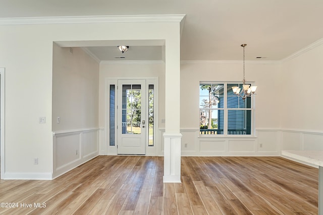 115 Genoes Point Rd SW, Supply, NC 28462 - entryway featuring light wood finished floors, a decorative wall, crown molding, decorative columns, and a chandelier