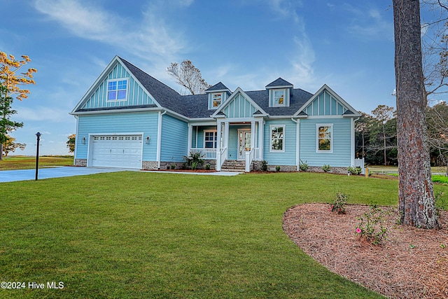 craftsman-style home with a porch, a garage, and a front yard