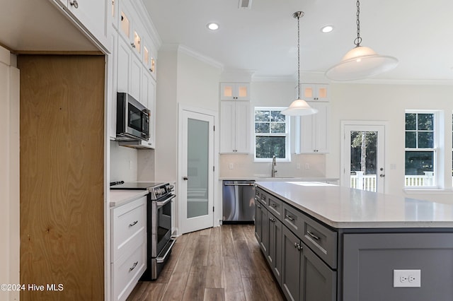 kitchen with gray cabinetry, decorative light fixtures, dark hardwood / wood-style flooring, white cabinetry, and stainless steel appliances