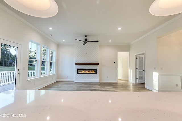 115 Genoes Point Rd SW, Supply, NC 28462 - unfurnished living room featuring recessed lighting, crown molding, a fireplace, a ceiling fan, and wood finished floors