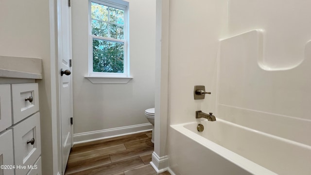 115 Genoes Point Rd SW, Supply, NC 28462 - full bath featuring toilet, baseboards, wood finished floors, and shower / bathtub combination