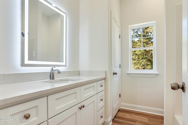 115 Genoes Point Rd SW, Supply, NC 28462 - bathroom with vanity, wood finished floors, and baseboards