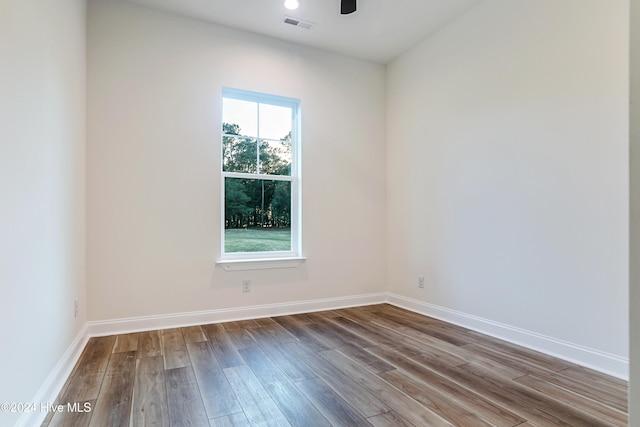 unfurnished room with wood-type flooring