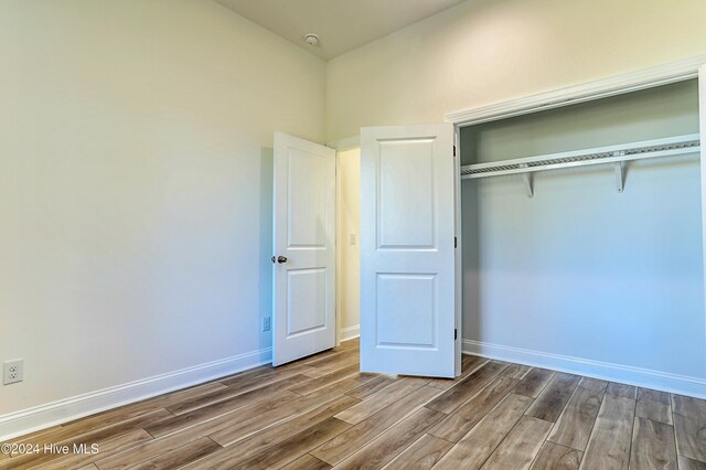 115 Genoes Point Rd SW, Supply, NC 28462 - unfurnished bedroom featuring wood finished floors, a closet, and baseboards