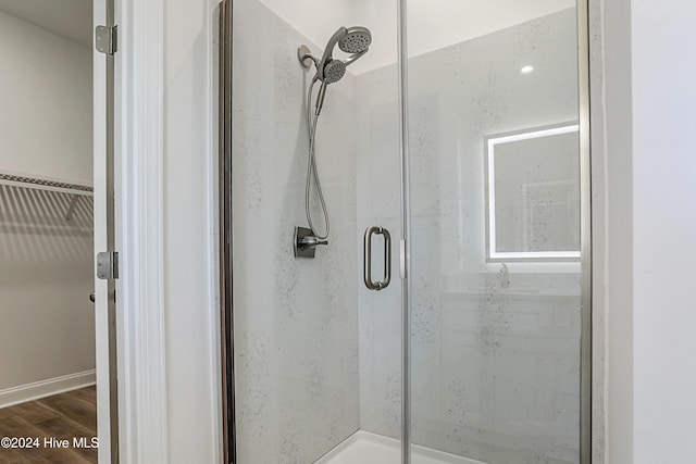 115 Genoes Point Rd SW, Supply, NC 28462 - bathroom with a stall shower and wood finished floors