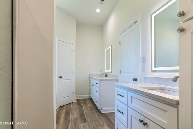 115 Genoes Point Rd SW, Supply, NC 28462 - full bathroom featuring two vanities, wood finished floors, recessed lighting, and baseboards