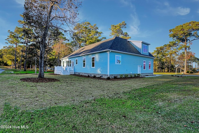 view of side of property with a yard