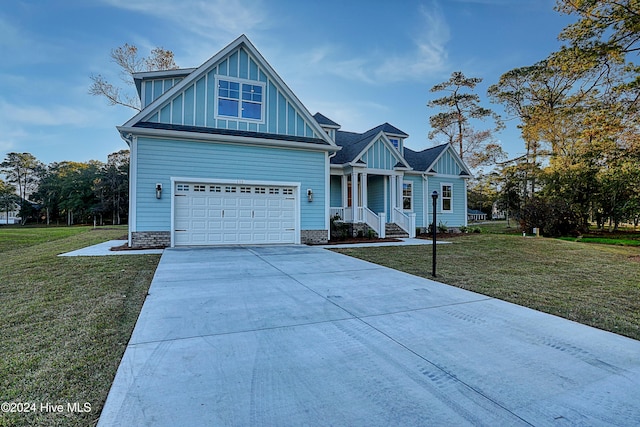 craftsman inspired home featuring a porch, a garage, and a front lawn