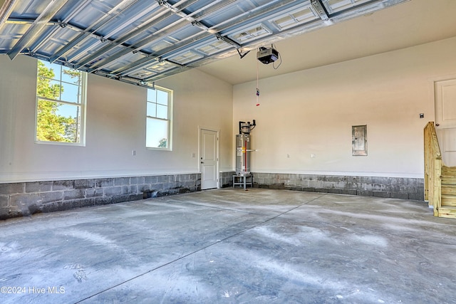 garage featuring a garage door opener and water heater