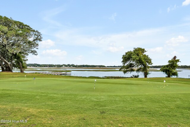 view of property's community featuring a water view and a lawn