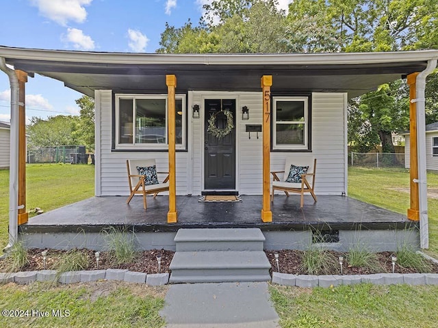 view of front of house with a porch and a front lawn