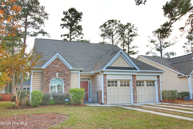 view of front of home featuring a garage and a front lawn