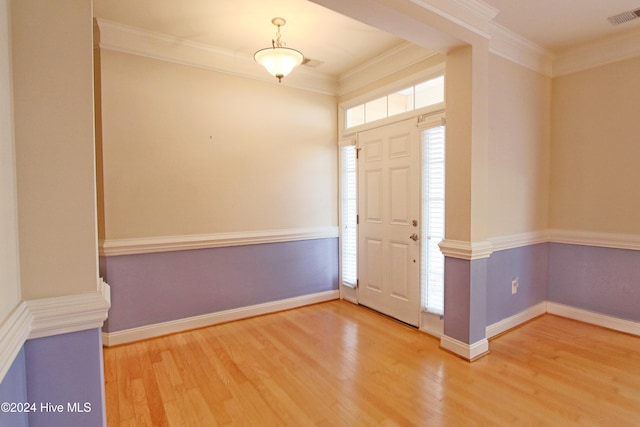 foyer entrance featuring hardwood / wood-style flooring and ornamental molding