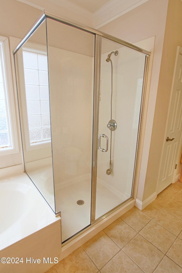 bathroom with tile patterned flooring, separate shower and tub, and crown molding