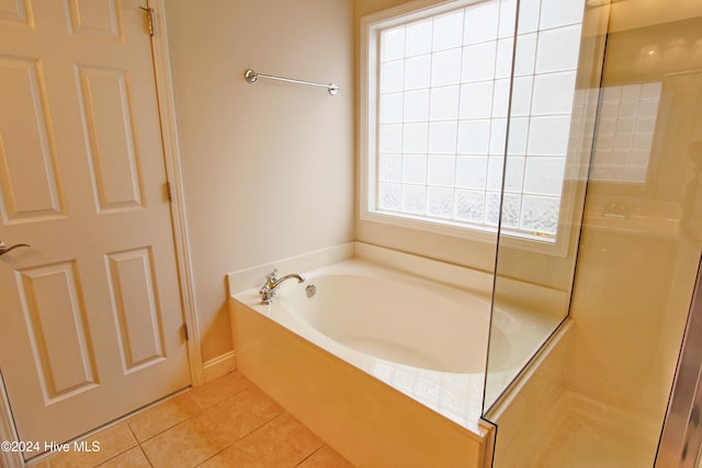 bathroom with tile patterned floors and shower with separate bathtub