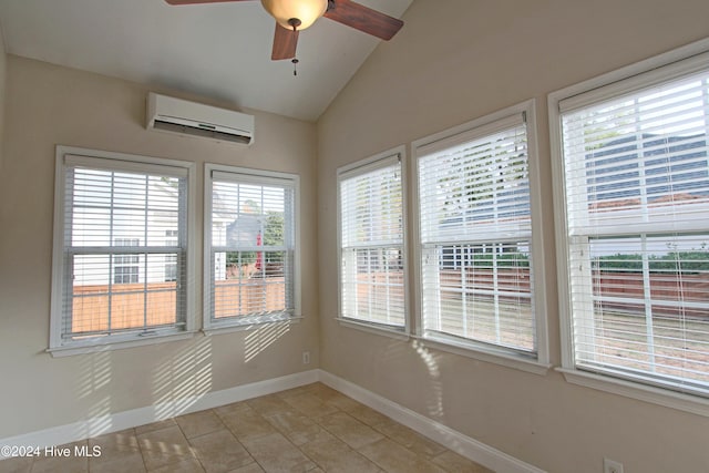 tiled empty room featuring a wall mounted air conditioner, ceiling fan, a healthy amount of sunlight, and vaulted ceiling