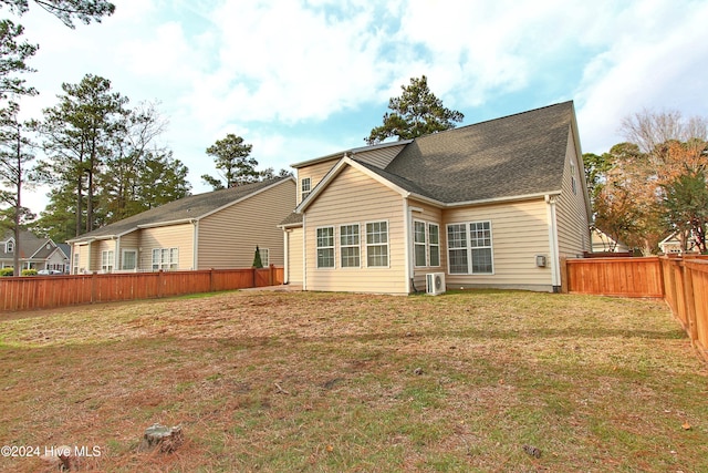 back of house featuring a yard