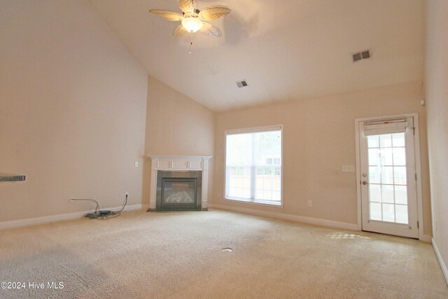 unfurnished living room with ceiling fan, light colored carpet, and high vaulted ceiling