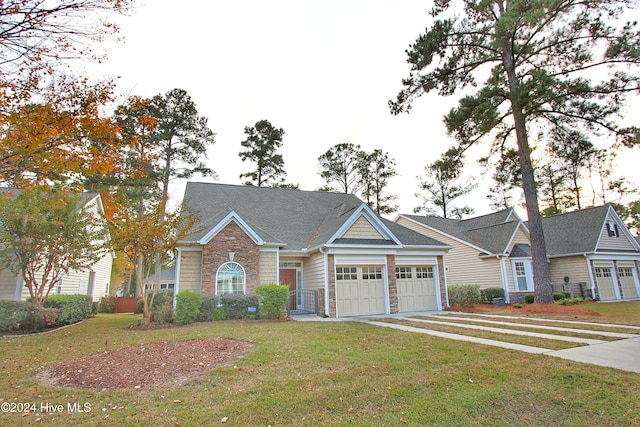 view of front of home with a front lawn and a garage