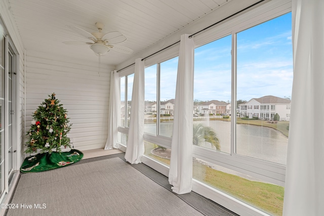 unfurnished sunroom featuring ceiling fan