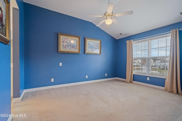 unfurnished room with light carpet, ceiling fan, and vaulted ceiling