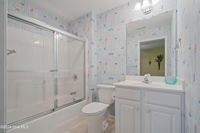 full bathroom featuring tile patterned floors, vanity, toilet, and shower / bath combination with glass door